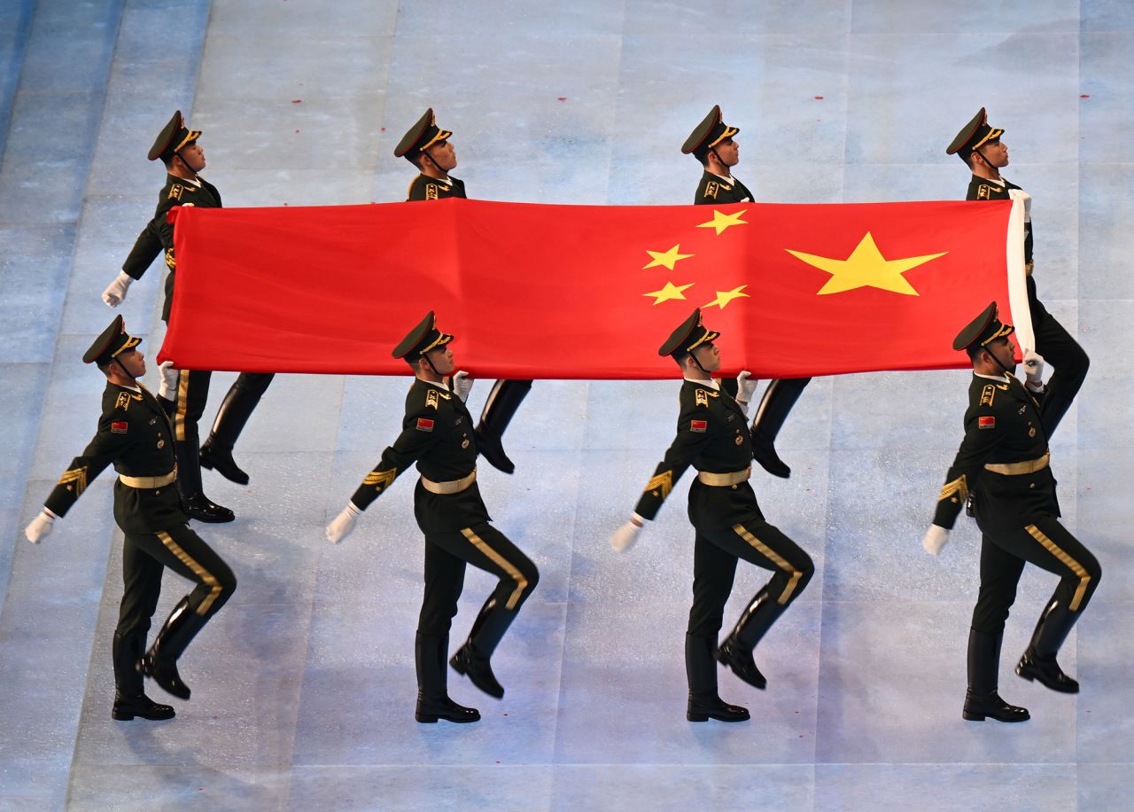 The Chinese flag is carried into the stadium.