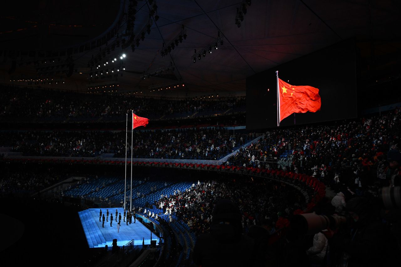 The Chinese flag is raised inside the stadium at the beginning of the opening ceremony.