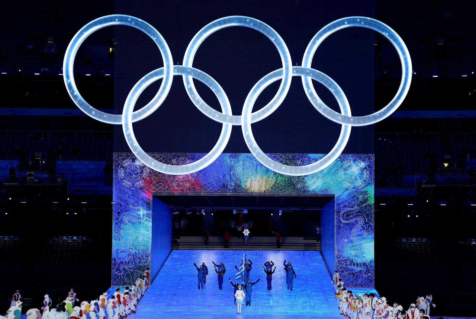 Athletes Apostolos Angelis and Maria Ntanou carry the flag of Greece at the start of the parade of nations. The athletes walked into the stadium via a <a href="index.php?page=&url=https%3A%2F%2Fwww.cnn.com%2Fworld%2Flive-news%2Fbeijing-winter-olympics-2022-opening-ceremony-spt-intl-hnk%2Fh_b41a124e1093c46f9deca8b7c6ad91bb" target="_blank">spectacular entrance</a> that is described as representing the "Gate of China" and "Window of China."