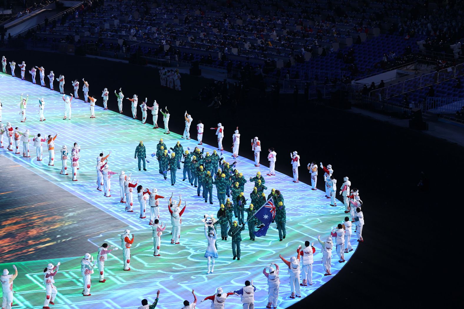 Athletes Brendan Kerry and Laura Peel carry the Australian flag during the parade of nations.