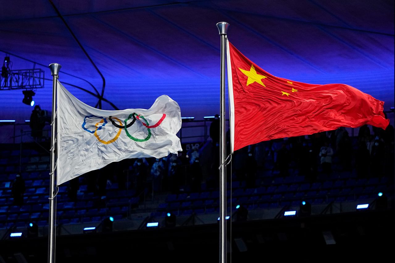 The Chinese and Olympic flags fly together at the opening ceremony.