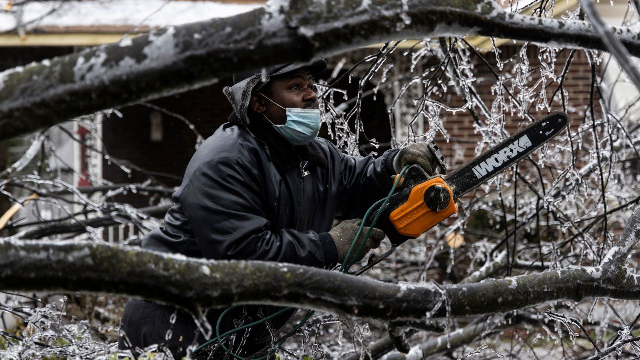 Edward Caldwell works to clear a downed tree at his mother's house in Memphis, Tennessee, on Thursday, February 3.