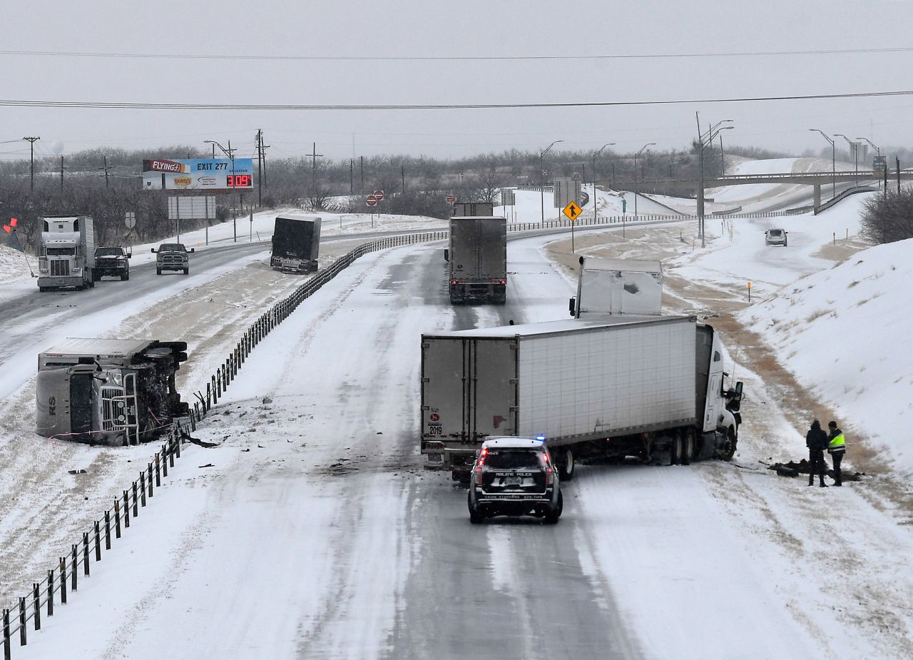 A police officer assists a truck driver on Interstate 20 in Abilene, Texas.