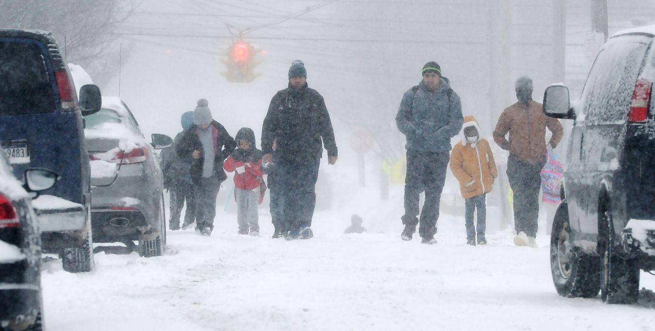 Parents and their children walk together after school in Erie, Pennsylvania, on February 3.