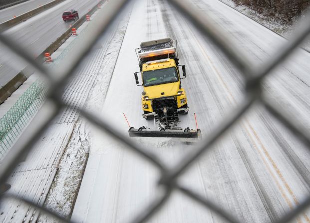 A snow plow clears a road in Columbus, Ohio.