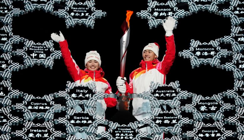 Chinese athletes Dinigeer Yilamujian, left, and Zhao Jiawen wave as they place the Olympic flame into a giant snowflake during the <a href="http://www.cnn.com/2022/02/04/sport/gallery/opening-ceremony-beijing-winter-olympics/index.html" target="_blank">opening ceremony</a> on February 4. The choice of Dinigeer and Zhao <a href="https://edition.cnn.com/world/live-news/beijing-winter-olympics-2022-opening-ceremony-spt-intl-hnk/h_4474af75fecfed6a2f010181e818974c" target="_blank">appeared symbolic and deliberate.</a> Dinigeer is a Uyghur, an ethnic minority in China's far west region of Xinjiang where China has been accused of massive human-rights violations. Zhao is of Han decent, the dominant ethnicity in China.