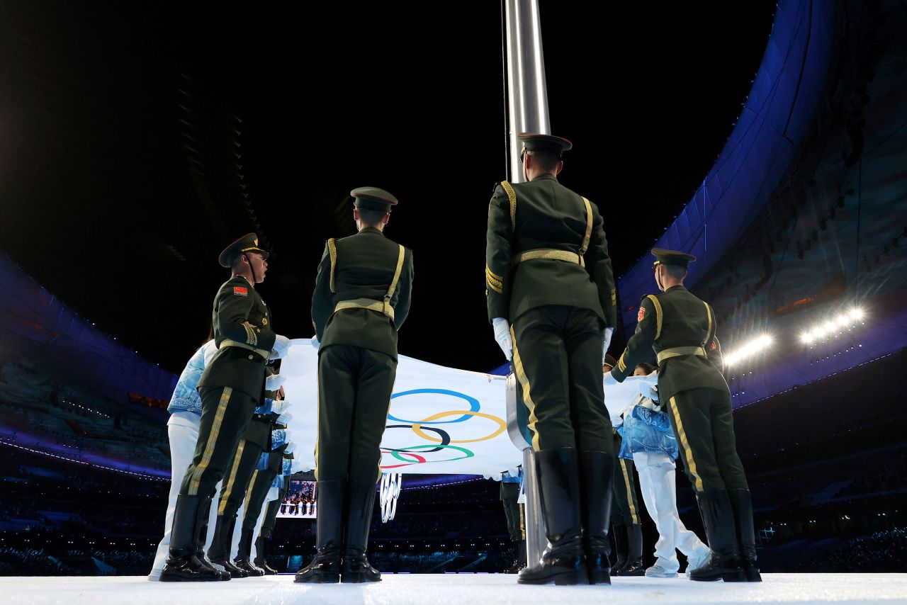 Soldiers prepare to raise the Olympic flag.