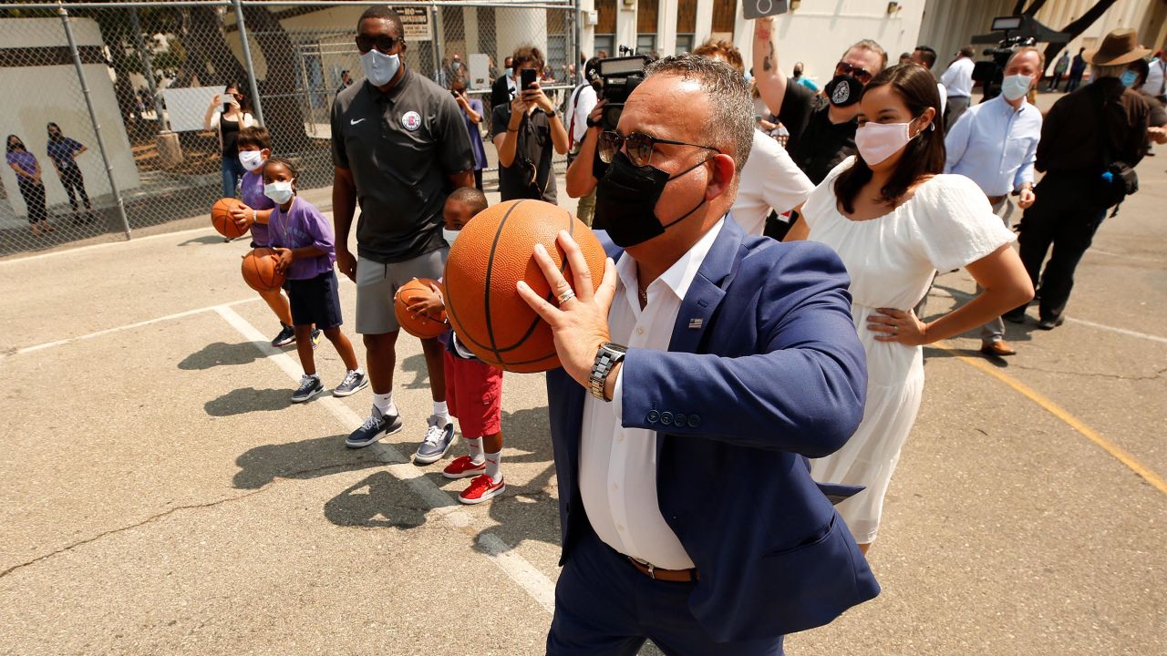 Education Secretary Miguel Cardona on the basketball court with mentors and students as he visits Fairfax High Schools Field Day event on July 14, 2021, in Los Angeles.