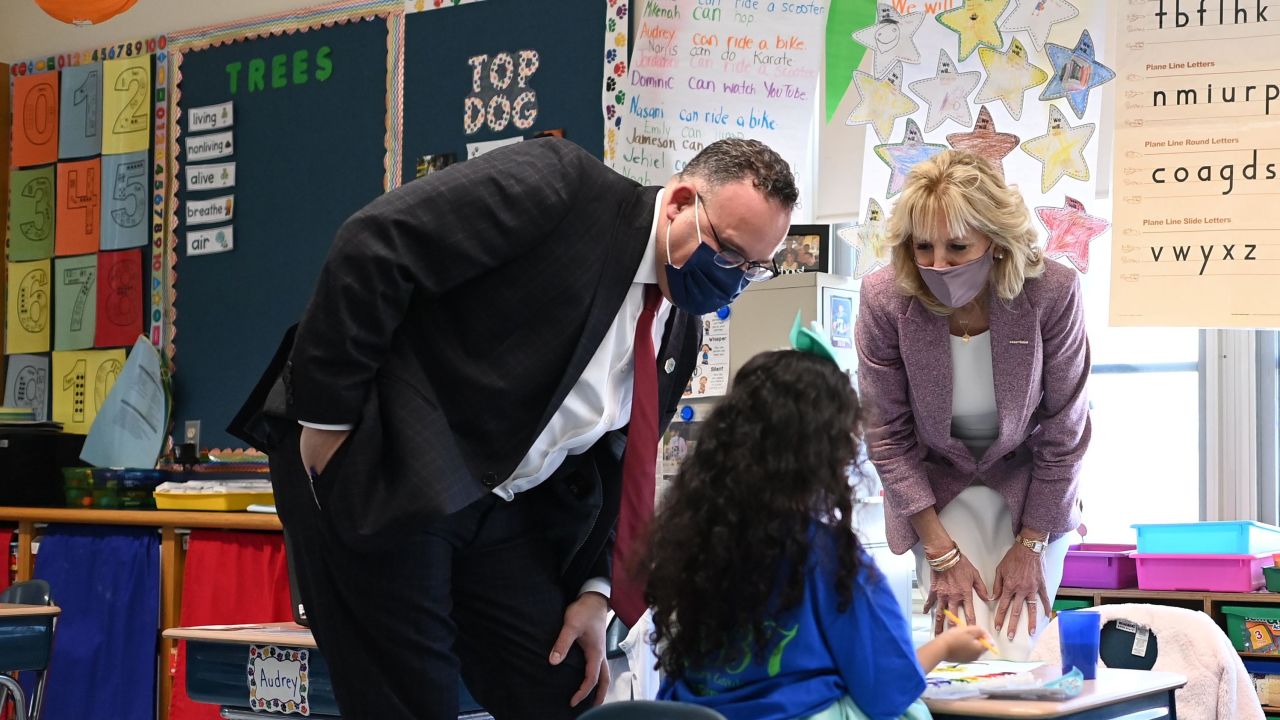 First Lady Jill Biden and Education Secretary Miguel Cardona speak with a student as they tour Benjamin Franklin Elementary School in Meriden, Connecticut, on March 3, 2021.