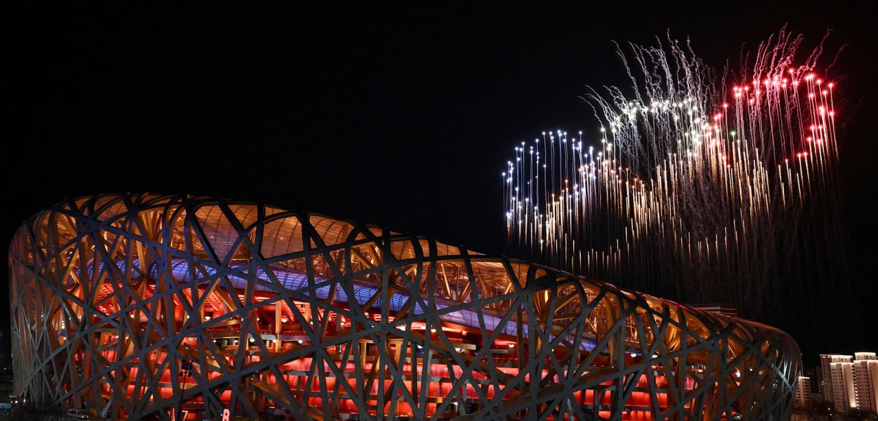 Fireworks burst in the shape of the Olympic rings.