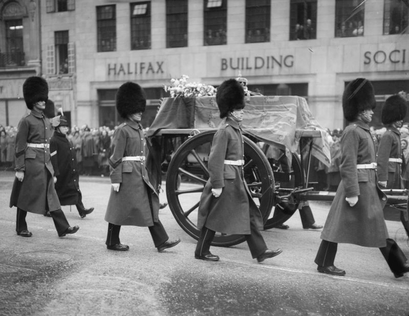 The funeral procession of King George makes its way through London.