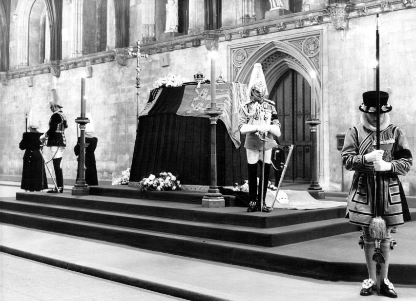 King George's coffin is guarded at Westminster Hall in London.