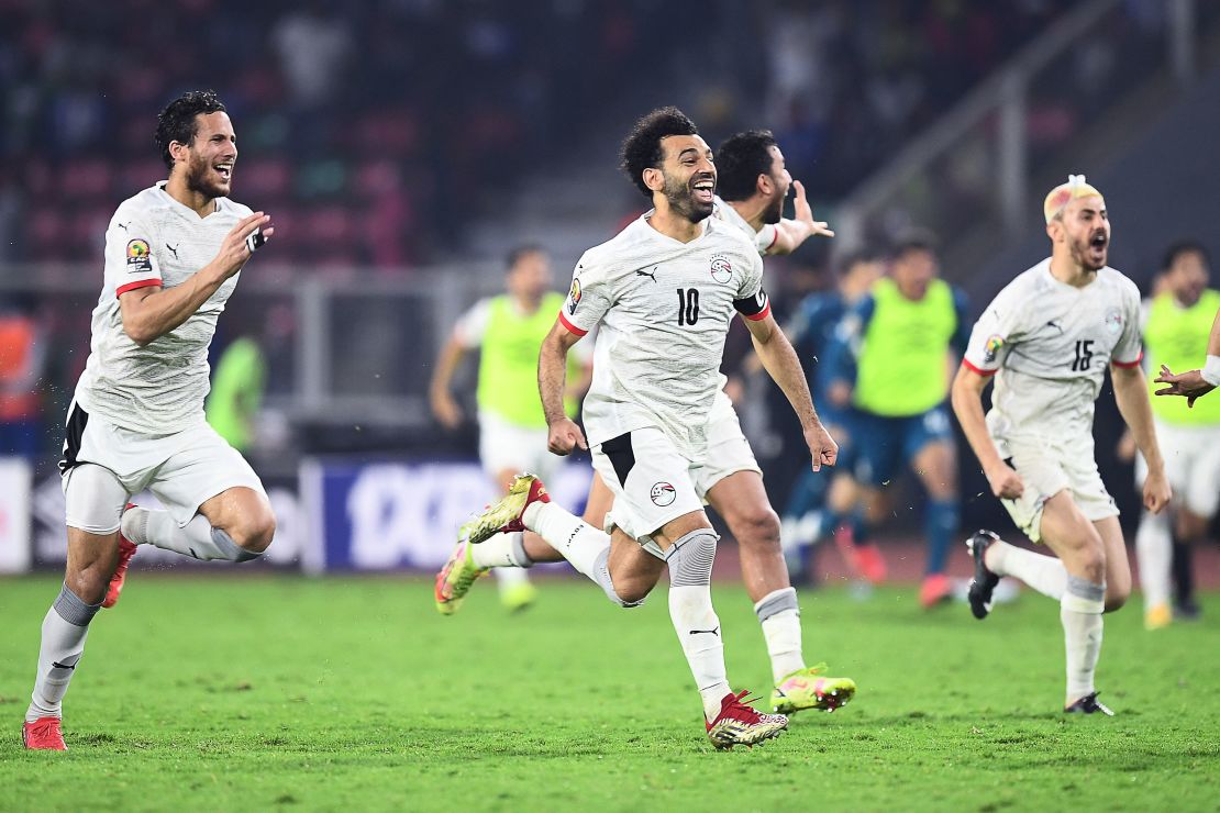 Mohamed Salah celebrates with teammates after winning the penalty shootout. 