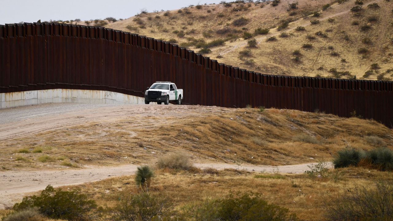 A US Border Patrol vehicle sits next to a border wall along the US-Mexico border on December 9, 2021 in Sunland Park, New Mexico.