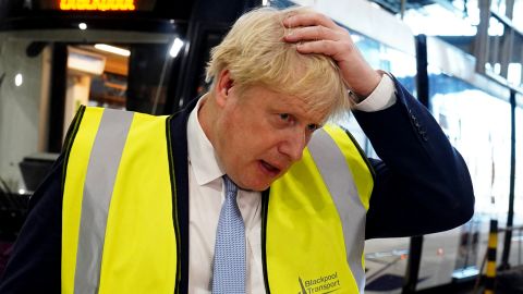 Britain's Prime Minister Boris Johnson gestures as he addresses members of the media during a visit to Blackpool Transport Depot in north west England on February 3, 2022. 