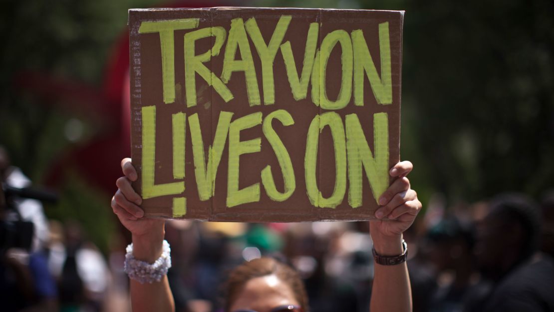 A woman holds a sign as she attends a rally honoring Trayvon Martin organized by the National Action Network outside One Police Plaza in Manhattan on July 20, 2013 in New York City.  