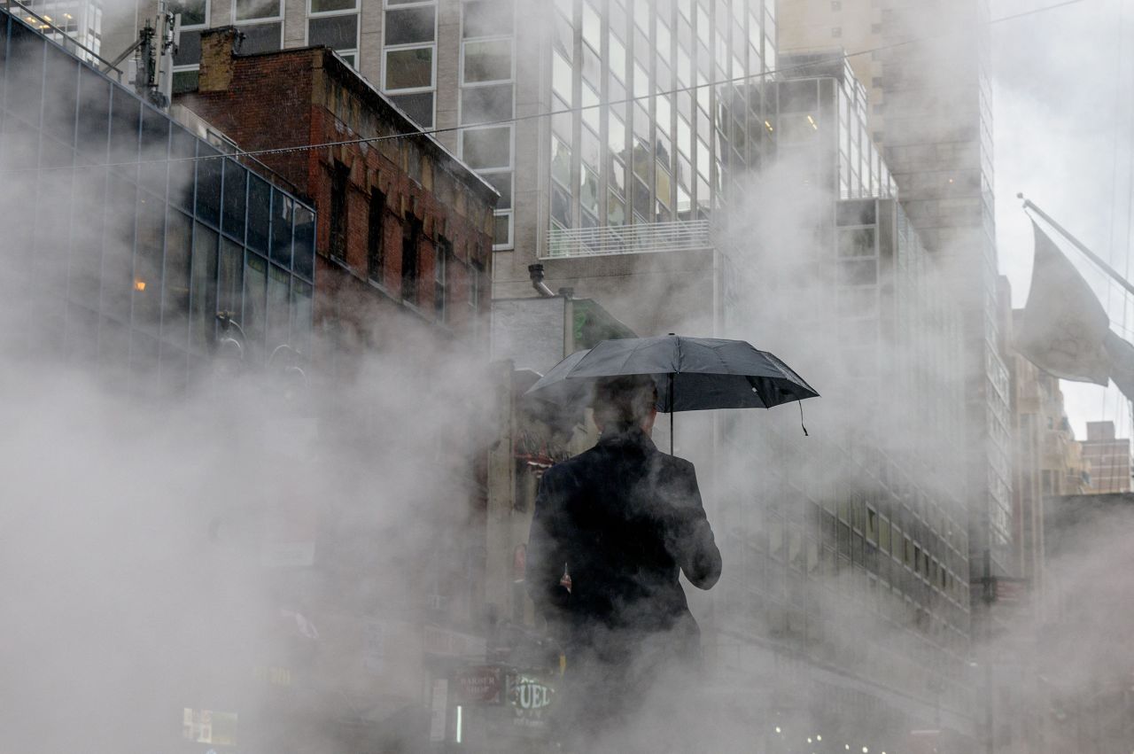 A pedestrian walks through steam on a rainy day in New York City on February 4.