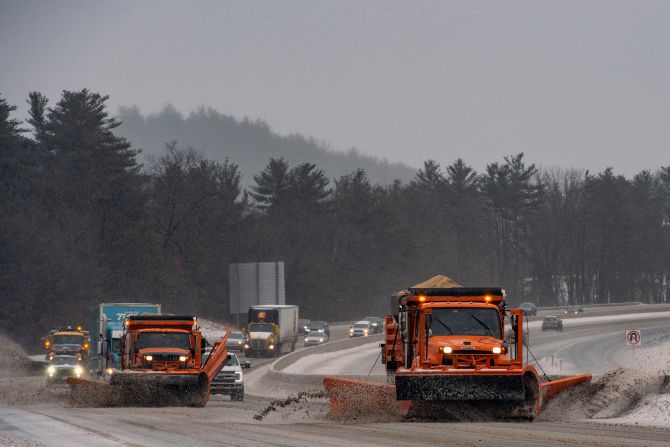 Plows clear snow and ice from Interstate 93 in Hooksett, New Hampshire, on February 4.
