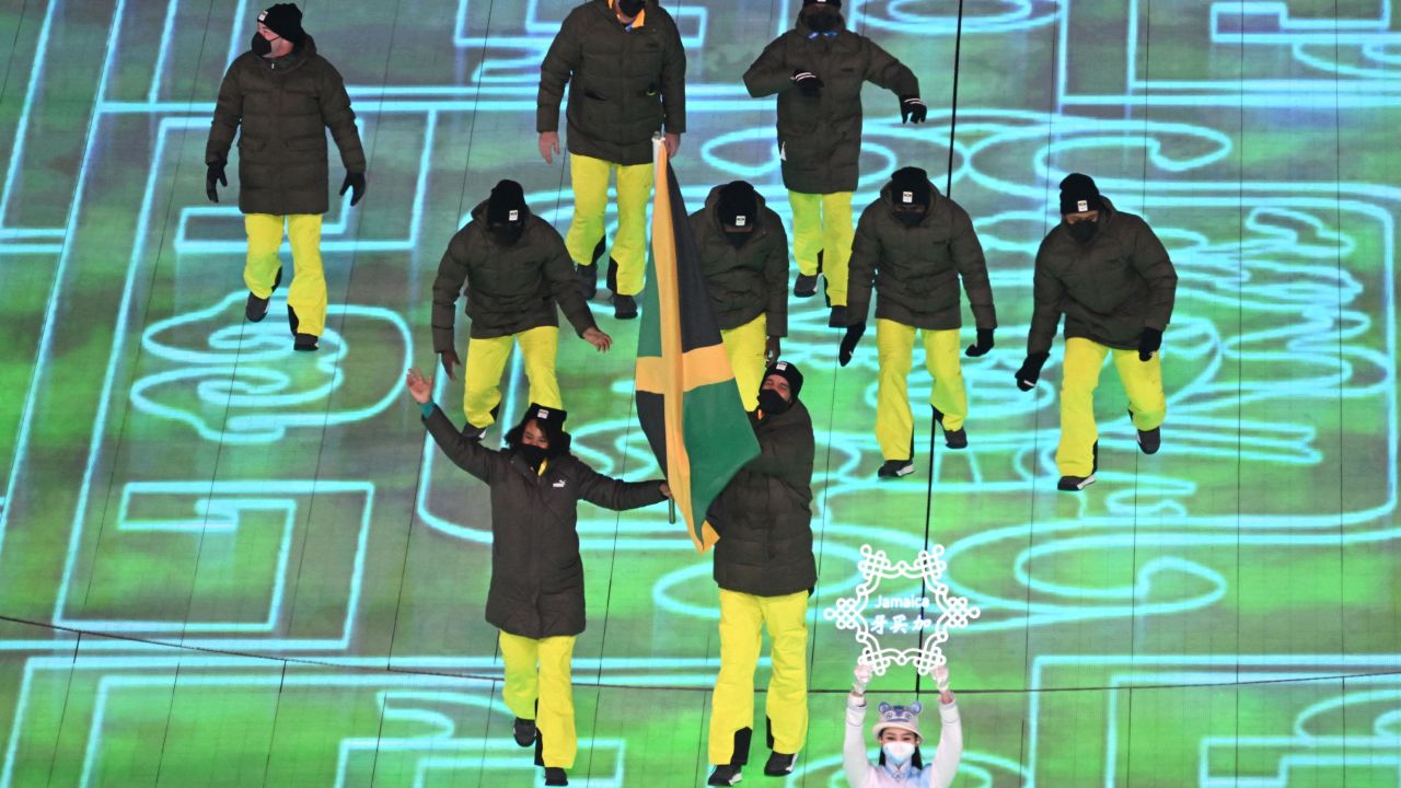 Jamaica's flag bearers Jazmine Fenlator-Victorian (L) and Benjamin Alexander enter the stadium leading Jamaica's delegation during the opening ceremony of the Beijing 2022 Winter Olympic Games, at the National Stadium, known as the Bird's Nest, in Beijing, on February 4, 2022.