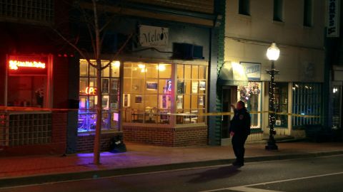 A police officer stands outside the Melody Hookah Lounge in Blacksburg, Virginia, after a shooting.