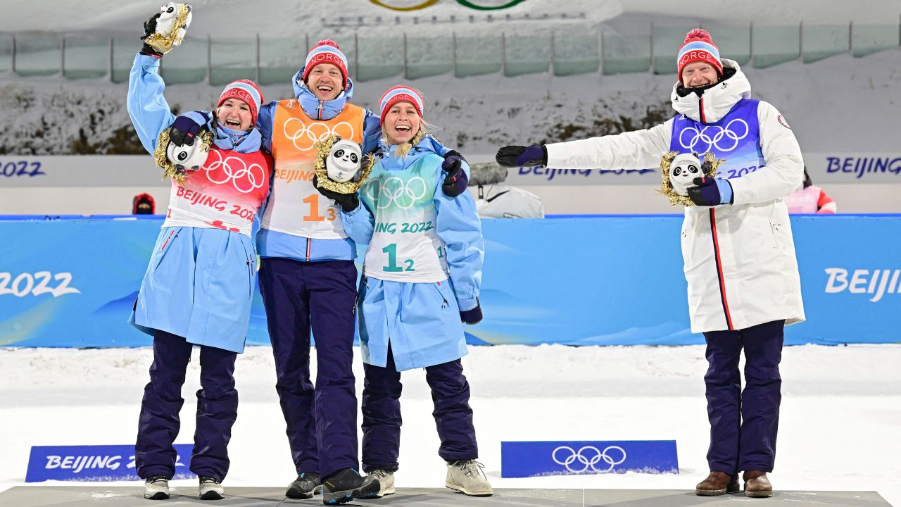 Norway's team of Olsbu Roeiseland, Johannes Thingnes Boe, Tiril Eckhoff and Tarjei Boe celebrate their first place on the podium.