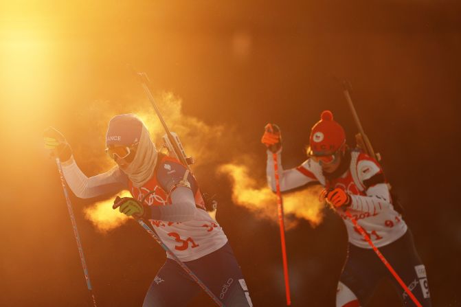 France's Anais Chevalier-Bouchet, left, skis during the biathlon mixed relay on February 5. France finished second behind Norway.