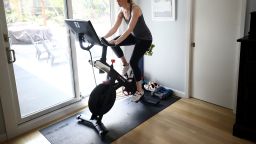 Jen Van Santvoord rides her Peloton exercise bike at her home on April 7, 2020 in San Anselmo, California.  