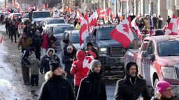 Trucks and supporters travel down Bloor Street during a demonstration in support of a trucker convoy in Ottawa protesting COVID-19 restrictions, in Toronto, Saturday, Feb. 5, 2022. (Nathan Denette/The Canadian Press via AP)