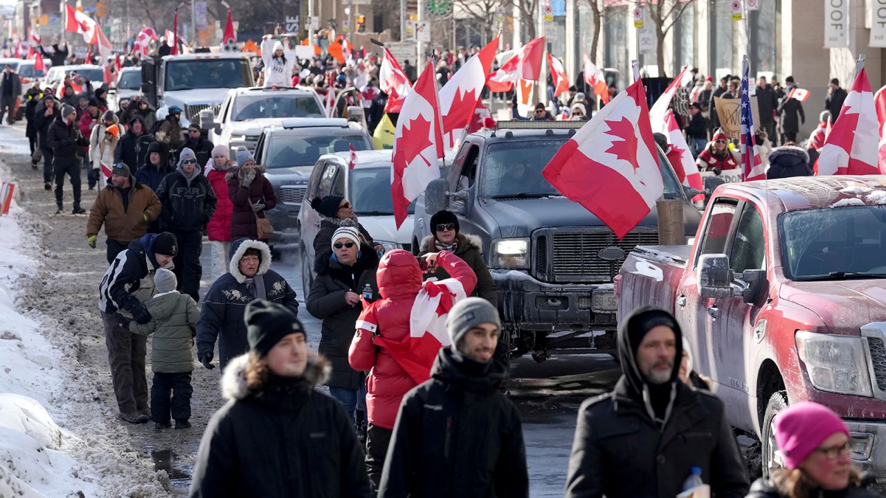 Trucks and supporters travel down Bloor Street during a demonstration in support of a trucker convoy in Ottawa on Saturday, February 5, 2022.