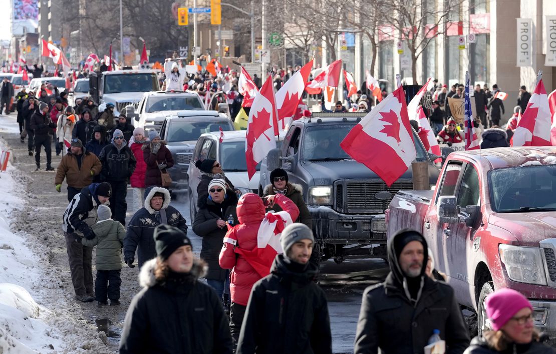 Trucks and supporters travel down Bloor Street during a demonstration in support of a trucker convoy in Ottawa on Saturday, February 5, 2022.