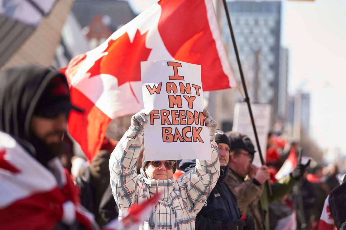 A demonstrator holds a sign during a protest against mandates related to Covid-19 vaccines and restrictions in downtown Toronto on February 5, 2022.