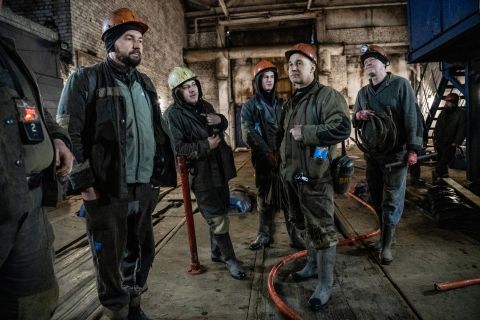 Miners wait for an elevator to take them below ground at the start of their shift in Vuhledar, Ukraine.