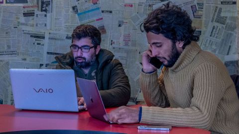 Fahad Shah, right, editor-in-chief of The Kashmir Walla, inside the newsroom at his office in Srinagar, Indian controlled Kashmir, Friday, Jan. 21, 2022. 