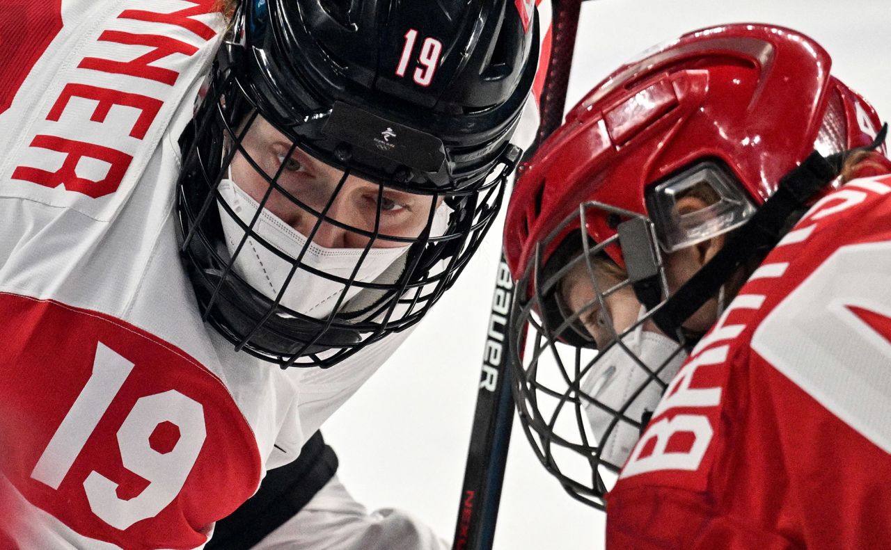Canadian hockey player Brianne Jenner, left, faces off against the Russian Olympic Committee's Oxana Bratishcheva during a preliminary round game at the Olympics on Monday, February 7. The game was delayed for an hour after the ROC's Covid-19 test results had not arrived on time. When the teams finally played, <a href="https://www.cnn.com/world/live-news/beijing-winter-olympics-02-07-22-spt/h_c00ab11cc129521b0e6f6f86644487b4" target="_blank">they wore masks under their cages.</a>