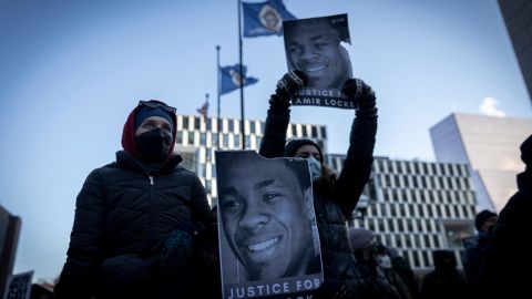 Demonstrators hold photos of Amir Locke during a rally in protest of his killing, outside the Hennepin County Government Center in Minneapolis on February 5, 2022. 