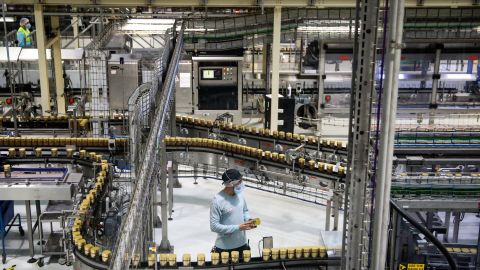 A worker checks a jar of Nestlé's instant coffee in the English city of Tutbury.