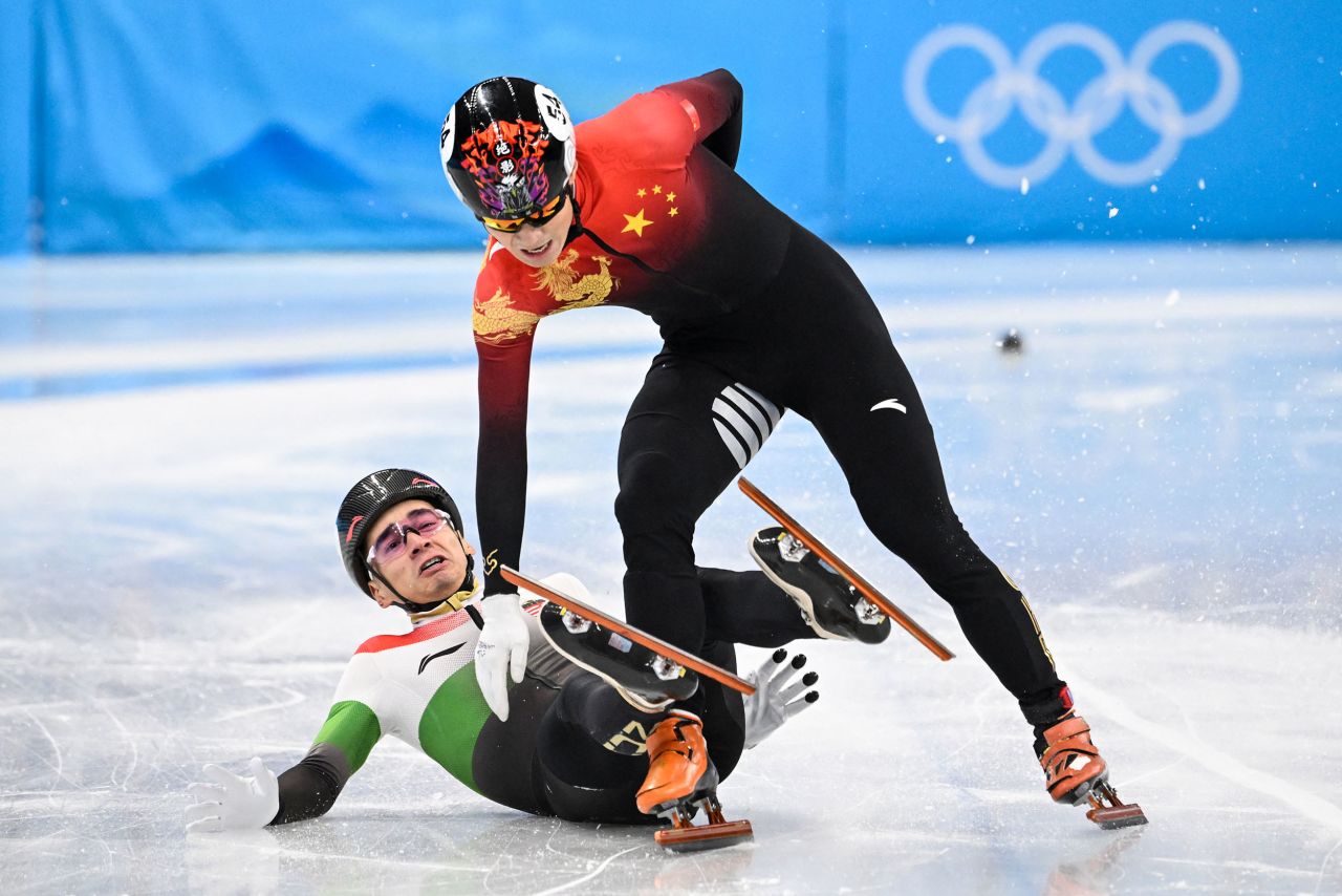 From left, Hungary's Shaolin Sándor Liu gets tangled up with China's Ren Ziwei after crossing the finish line in the 1,000-meter short track final on February 7. Liu crossed the finish line first, but <a href="https://www.cnn.com/world/live-news/beijing-winter-olympics-02-07-22-spt/h_45a9864b48e80e22a0b20b7378fcf05b" target="_blank">Ren was awarded the gold medal</a> after Liu was given a yellow card and two penalties for illegally changing lanes and causing contact with Ren.