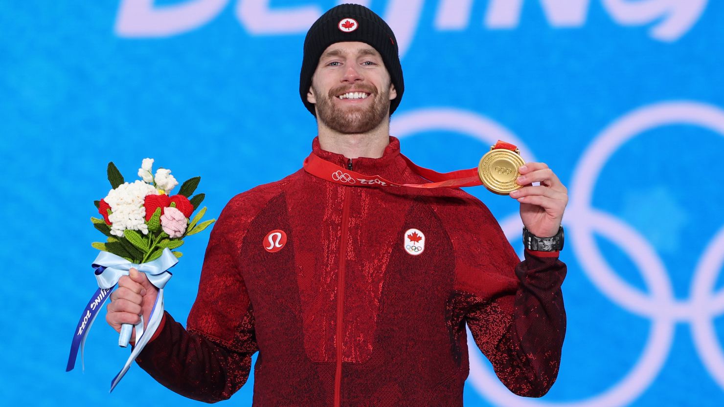Gold medalist Max Parrot celebrates with his medal during the men's snowboarding slopestyle medal ceremony at Medal Plaza on February 7, 2022.