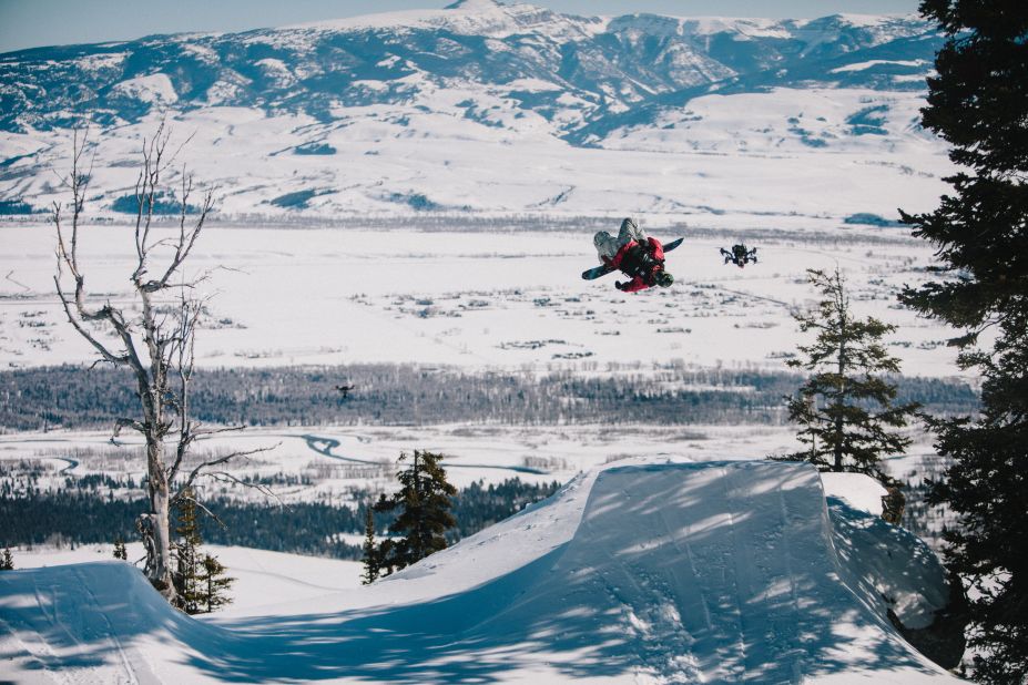 Kocher says that he has to tap into his seven years' experience as a professional drone racer in order to keep up with the riders -- simultaneously predicting their routes, engineering the best possible filming angles, and avoiding the trees dotted across the mountainside. Pictured, Sage Kotsenburg and a drone in Jackson Hole.