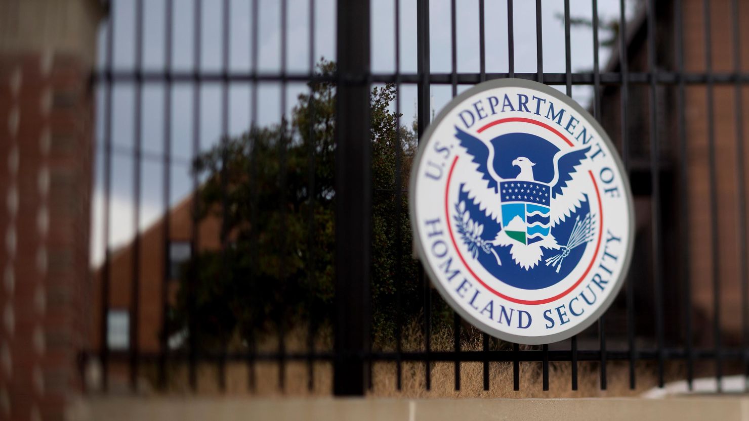 The US Department of Homeland Security seal hangs on a fence at the agency's headquarters in this photo taken with a tilt-shift lens in Washington in December 2014. 