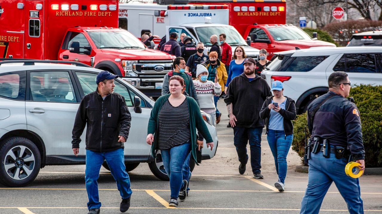 People leave the Fred Meyer grocery store after Monday's deadly shooting.