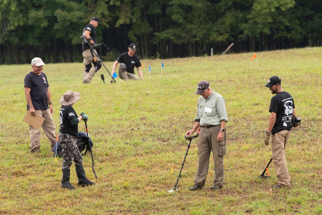 Veterans are taught how to use metal detectors in the field.