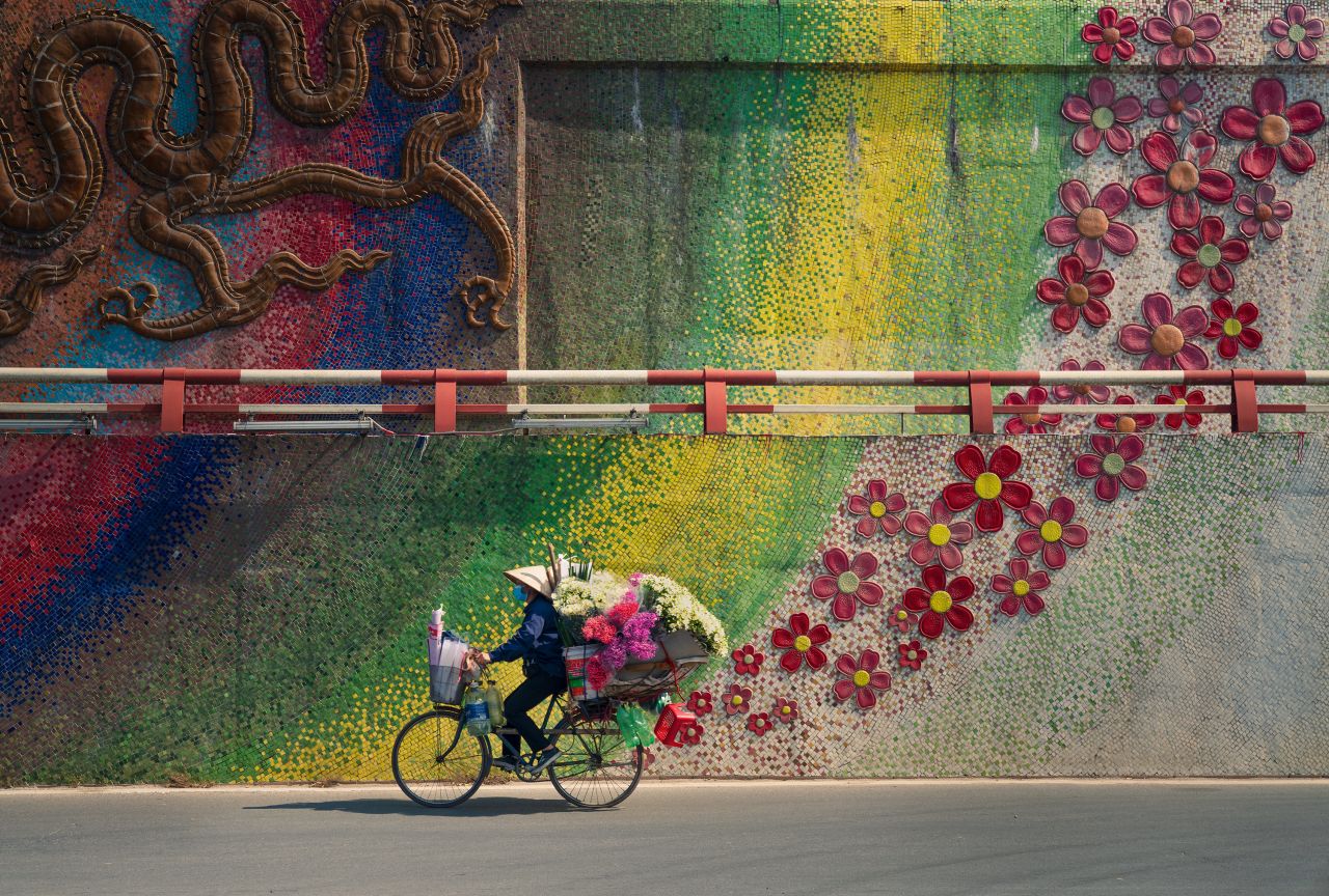 Vietnamese photographer Thanh Nguyen Phuc's photo "Bike with Flowers" conveys the vibrant street culture in the capital city of Hanoi, where vendors ride their bikes.
