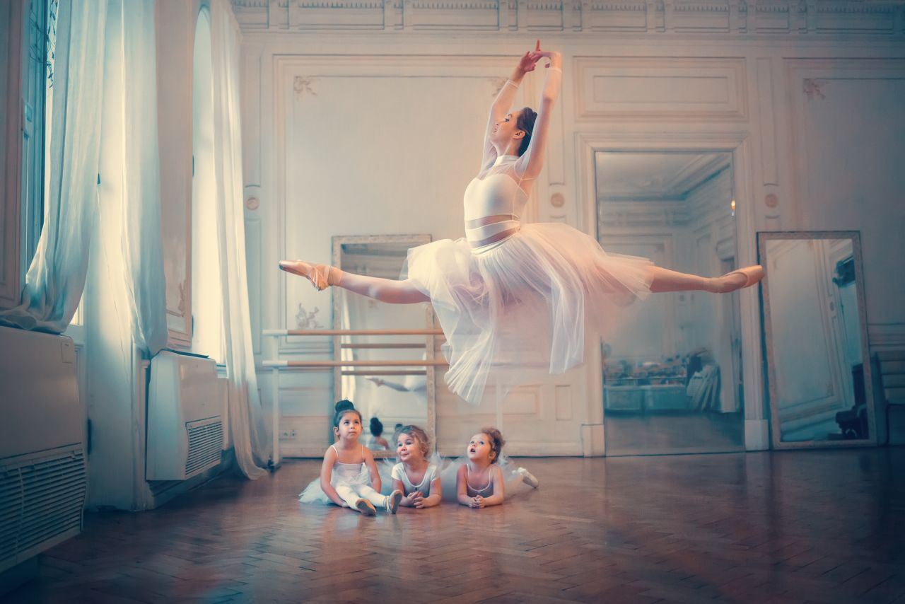 Russian Federation winner Marianna Smolina shot a frozen flight of an adult ballerina under the gaze of three young girls in "The Flight."