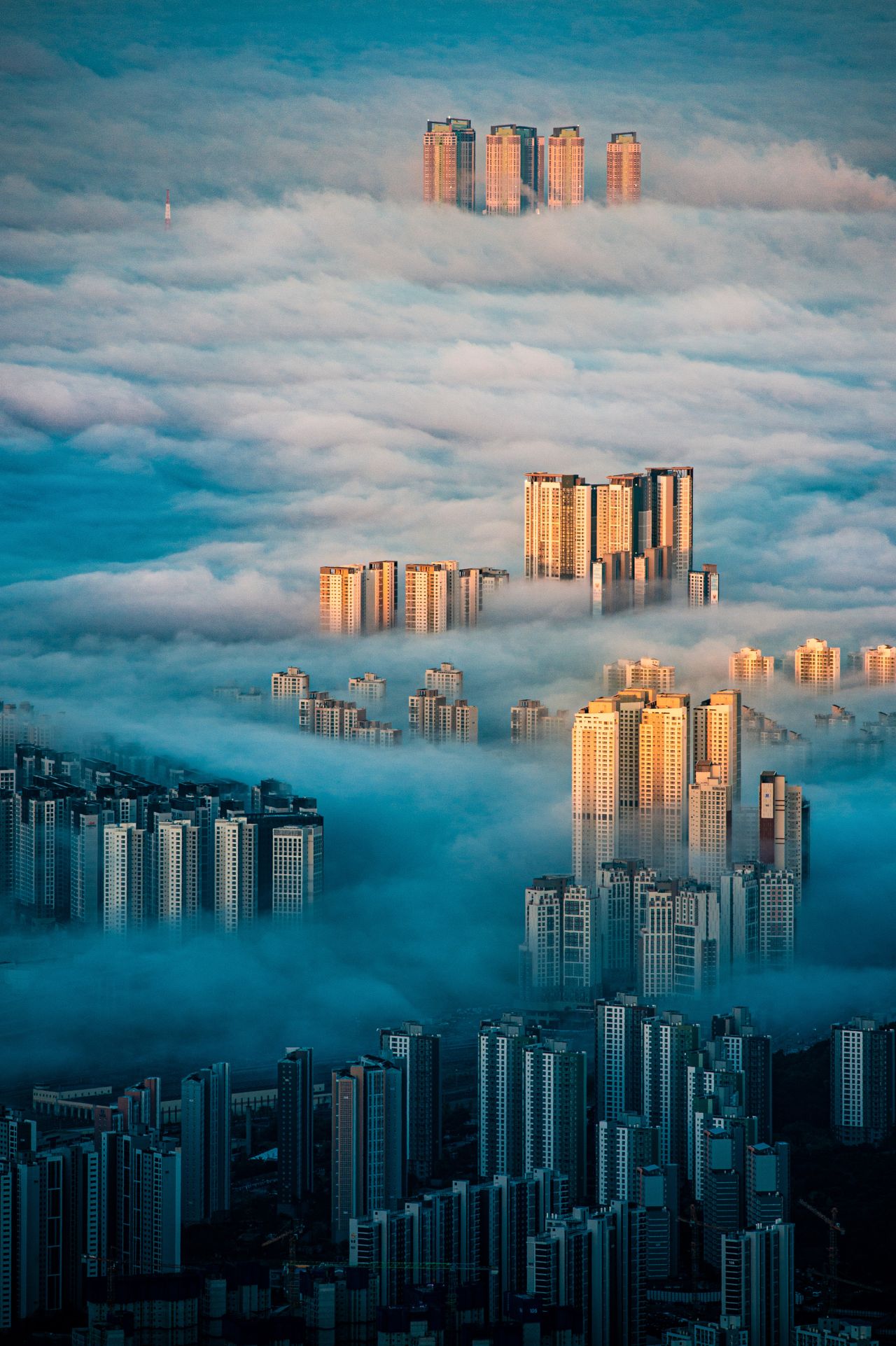 "A City Among the Clouds," by Wonyoung Choi captures the clouds snaking through the Bukhansan Mountain in Seoul, South Korea. 