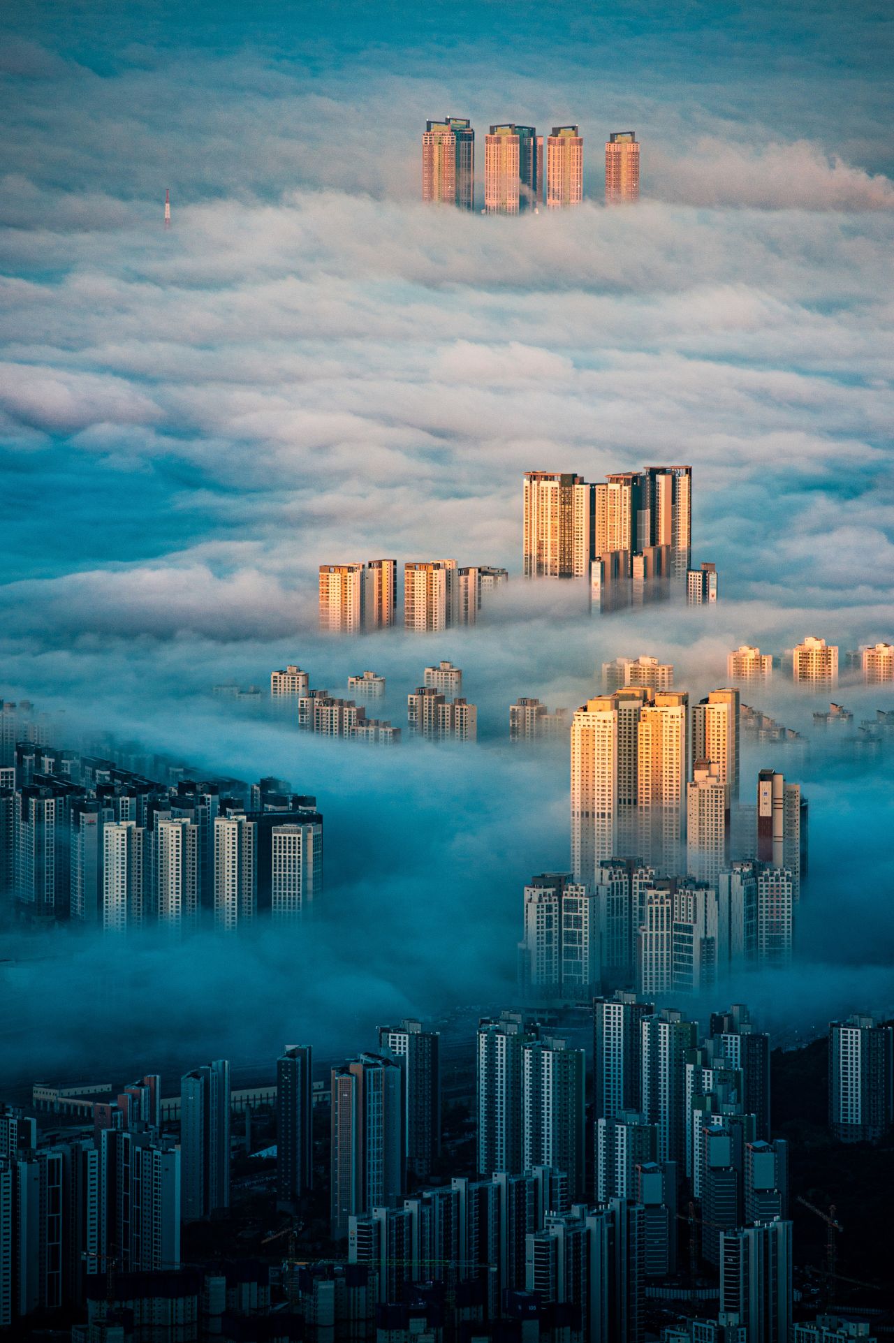 "A City Among the Clouds," by Wonyoung Choi captures the clouds snaking through the Bukhansan Mountain in Seoul, South Korea.