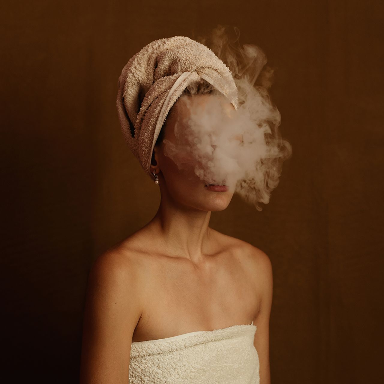Greek photographer Foteini Zaglara's self portrait, "Rolling Boil," shows her as she blows a plume of smoke into the camera. 