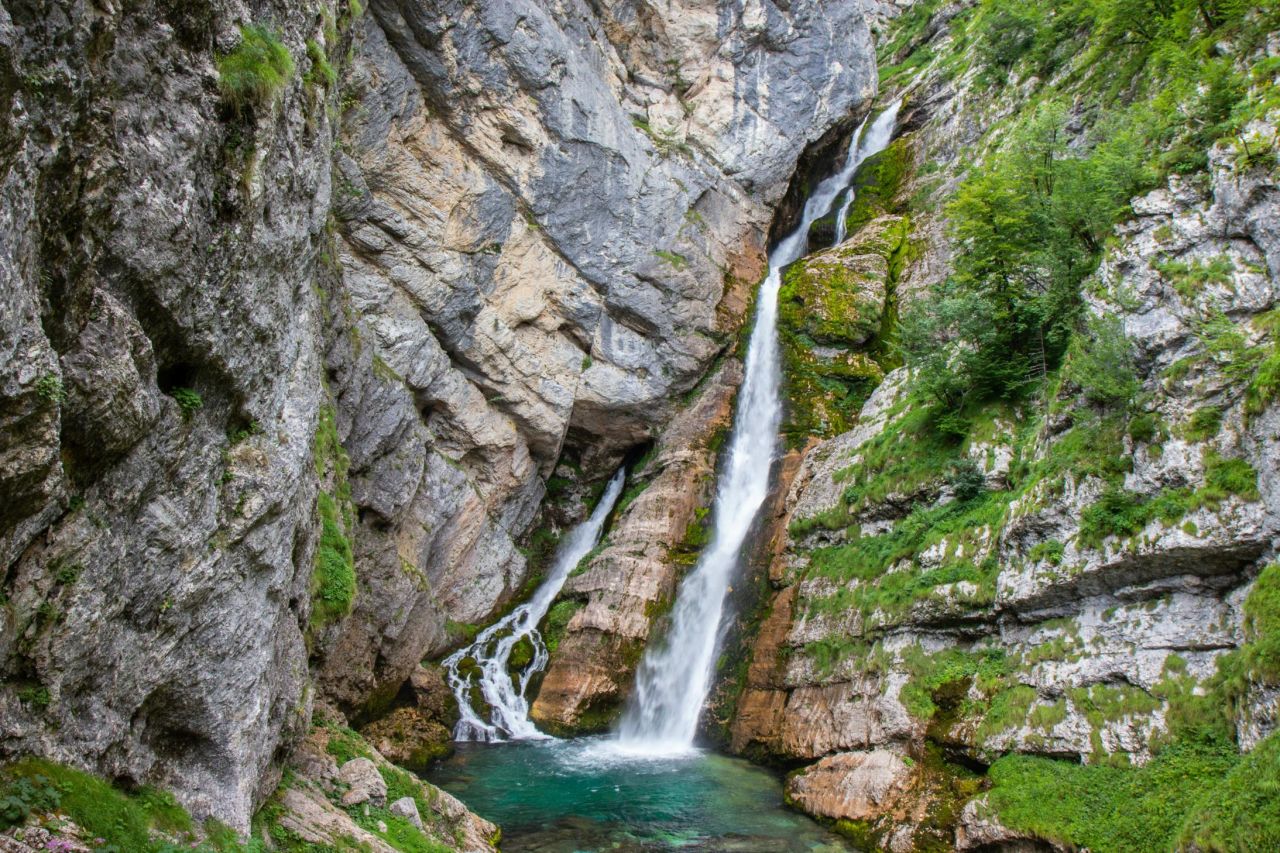 <strong>Savica Waterfall:</strong> One of Slovenia's loveliest natural attractions, this cascade sees water plunge through a deep crevasse into a brilliant emerald-green pool below. 