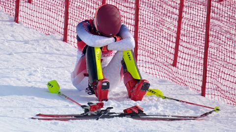 Mikaela Shiffrin sits on the side of the course after skiing out in the first run of the women's slalom.