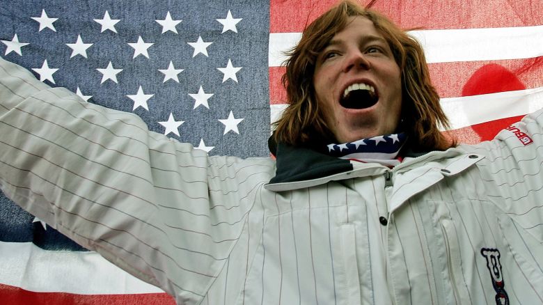 American snowboarder Shaun White celebrates on the podium after winning a gold medal at the 2006 Winter Olympics in Italy.